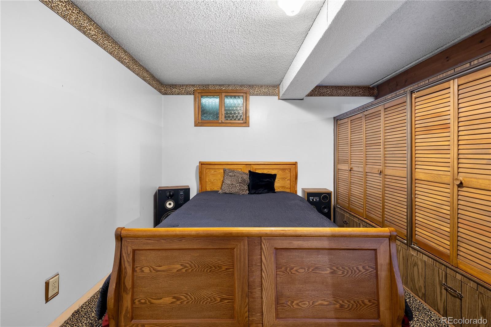 5311 Troy Street Denver, CO 80239 - Photo 41 of 46 a bedroom with a bed and a window