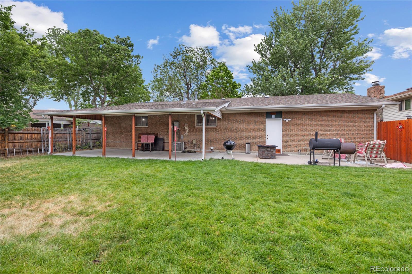 5311 Troy Street Denver, CO 80239 - Photo 42 of 46 a view of a house with backyard porch and furniture