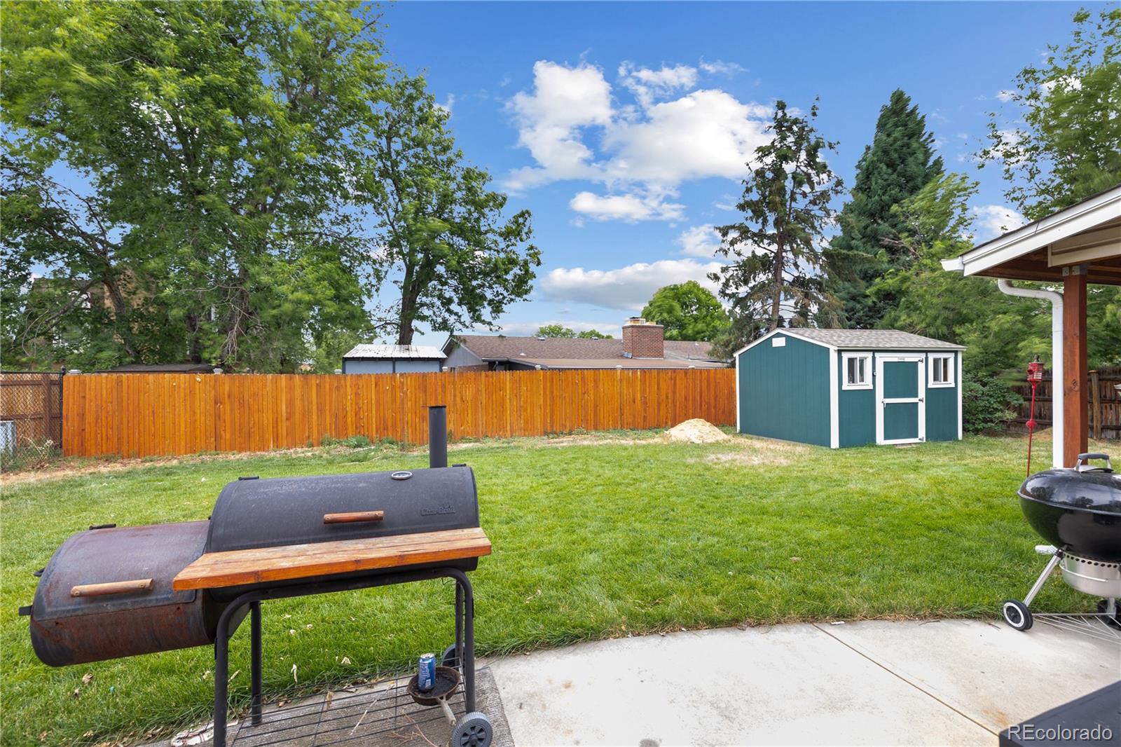 5311 Troy Street Denver, CO 80239 - Photo 43 of 46 a backyard of a house with table and chairs