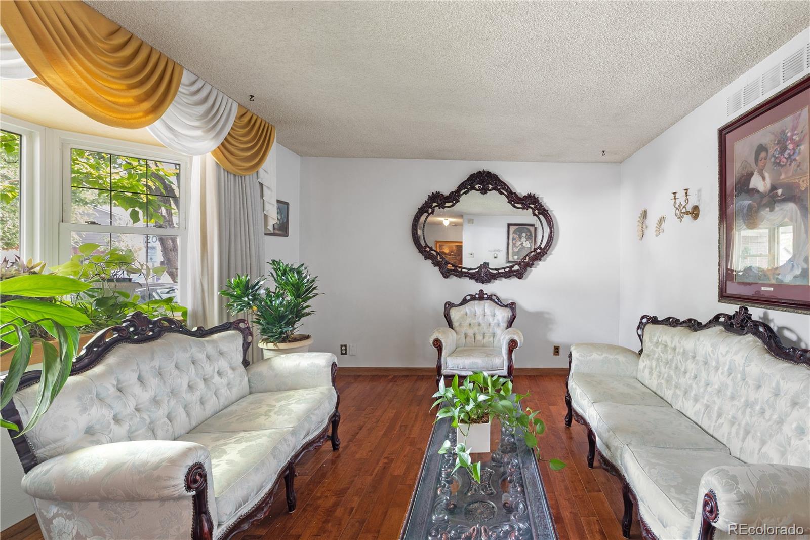 5311 Troy Street Denver, CO 80239 - Photo 6 of 46 a living room with furniture and a large window