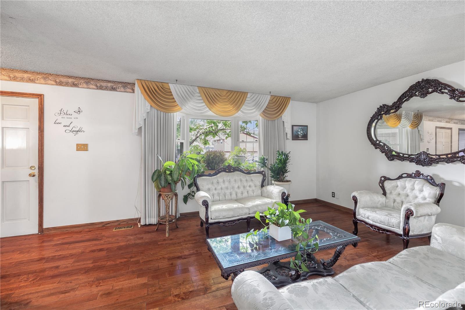 5311 Troy Street Denver, CO 80239 - Photo 7 of 46 a living room with furniture potted plant and a large window
