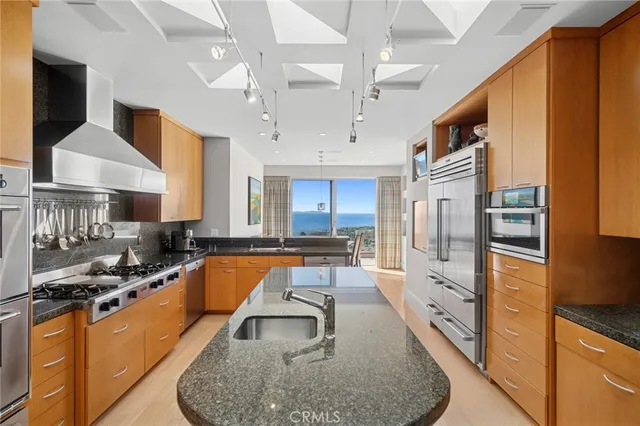 a kitchen with stainless steel appliances granite countertop a stove sink and cabinets