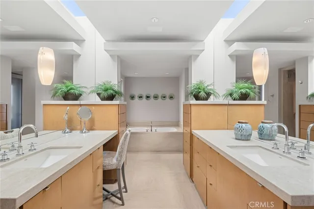 a spacious bathroom with a granite countertop sink a mirror and a shower