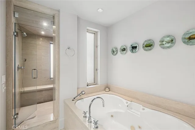 a bathroom with a bathtub and a shower