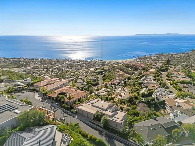 an aerial view of residential building and ocean view in back