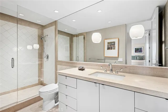 a bathroom with a double vanity sink mirror and toilet
