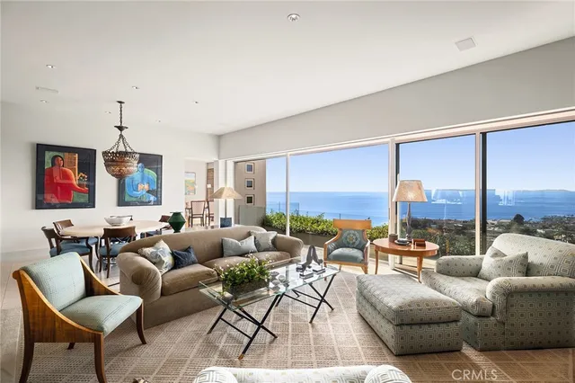 a living room with furniture city view and large windows