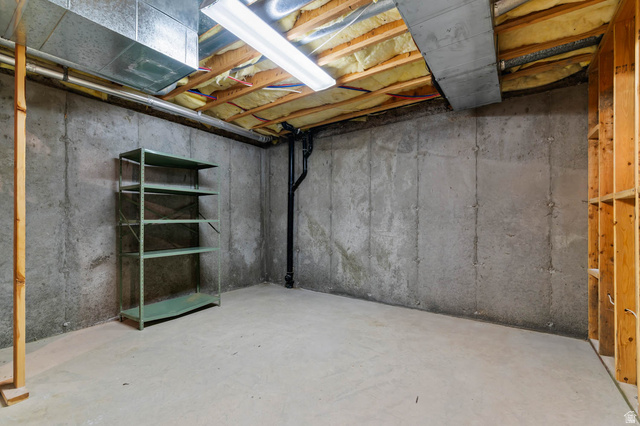 1417 Blacksmith Lane Draper, UT 84020 - Photo 41 of 57 Unfinished basement space featuring concrete walls and flooring, exposed ceiling joists with insulation, and visible ductwork
