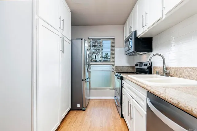 a kitchen with a sink a stove and a microwave