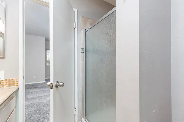 a bathroom with a glass shower door