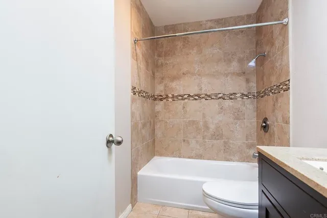 a bathroom with a bathtub shower and toilet