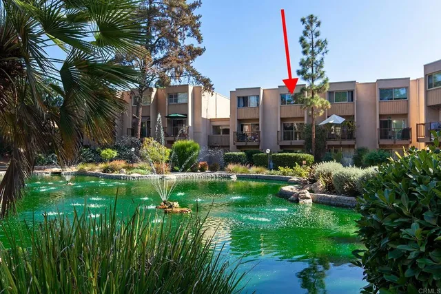 a front view of a house with plants