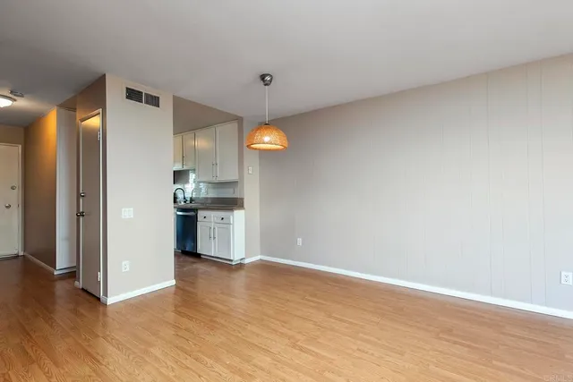 a view of a kitchen with a sink and a refrigerator