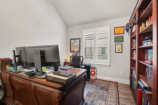 a view of a workspace with furniture and a window