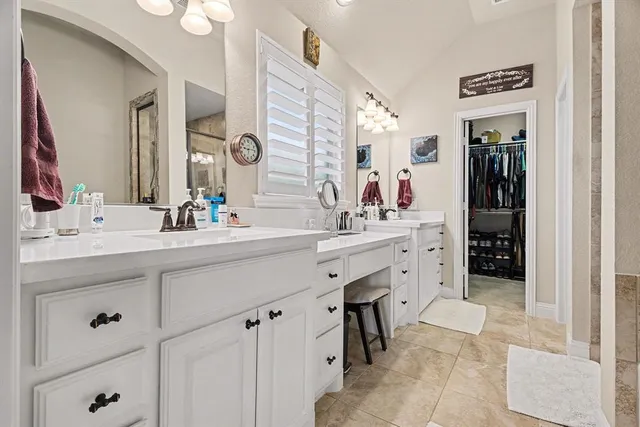 a spacious bathroom with a double vanity sink double and a mirror