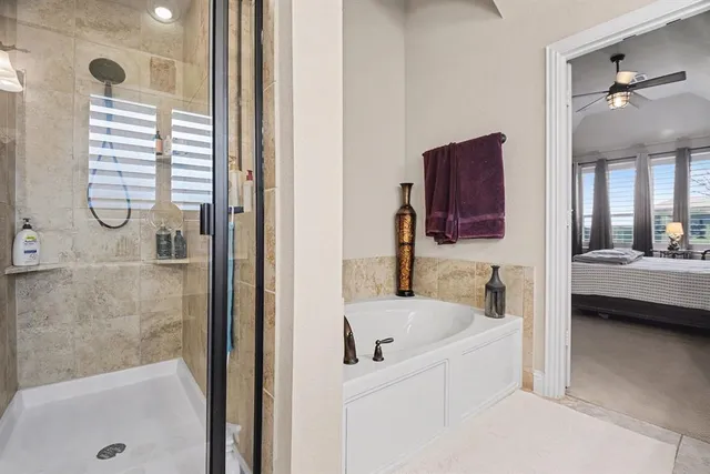 a bathroom with a tub sink and mirror