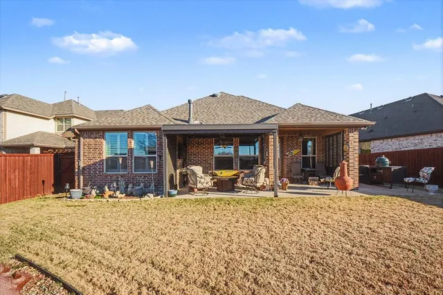 a front view of a house with a yard outdoor seating and barbeque oven