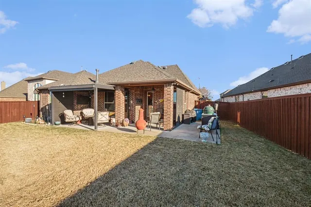 a view of a house with backyard porch and sitting area