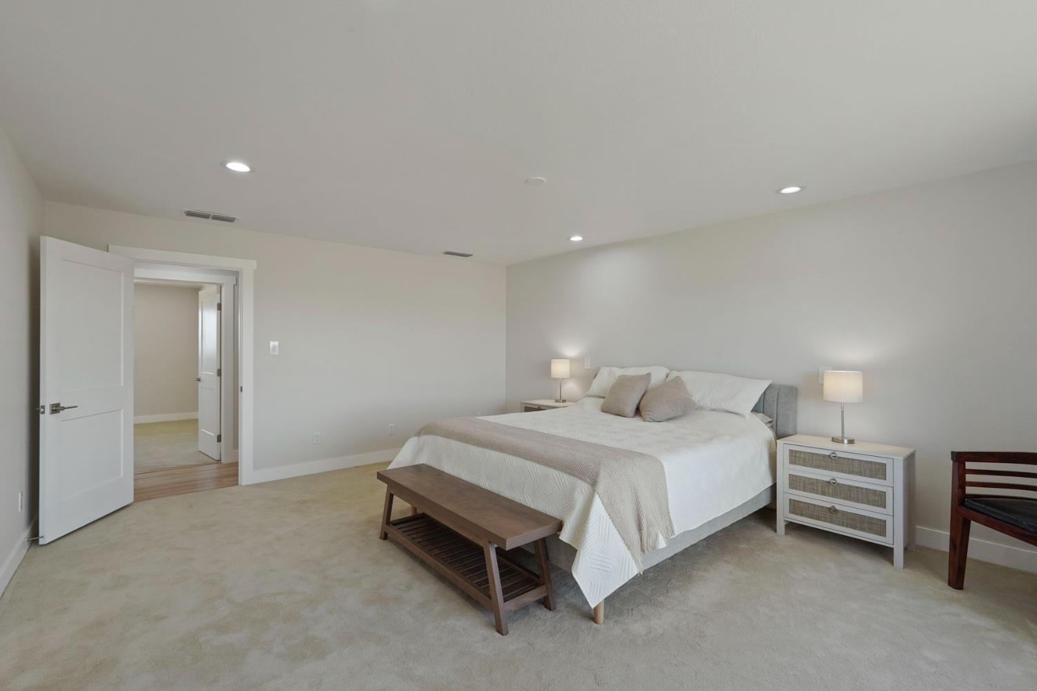 2650 West Twitchell Island Road Rio Vista, CA 94571 - Photo 20 of 60 a spacious bedroom with a bed and a lamp