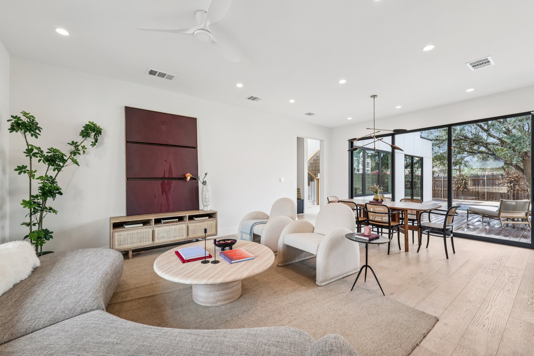 Living room featuring light wood-style floors, ceiling fan, and recessed lighting
