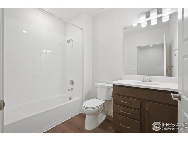 a bathroom with a sink a toilet and a large mirror