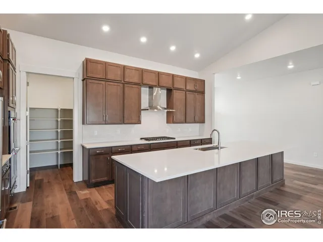 a kitchen with a sink cabinets and wooden floor