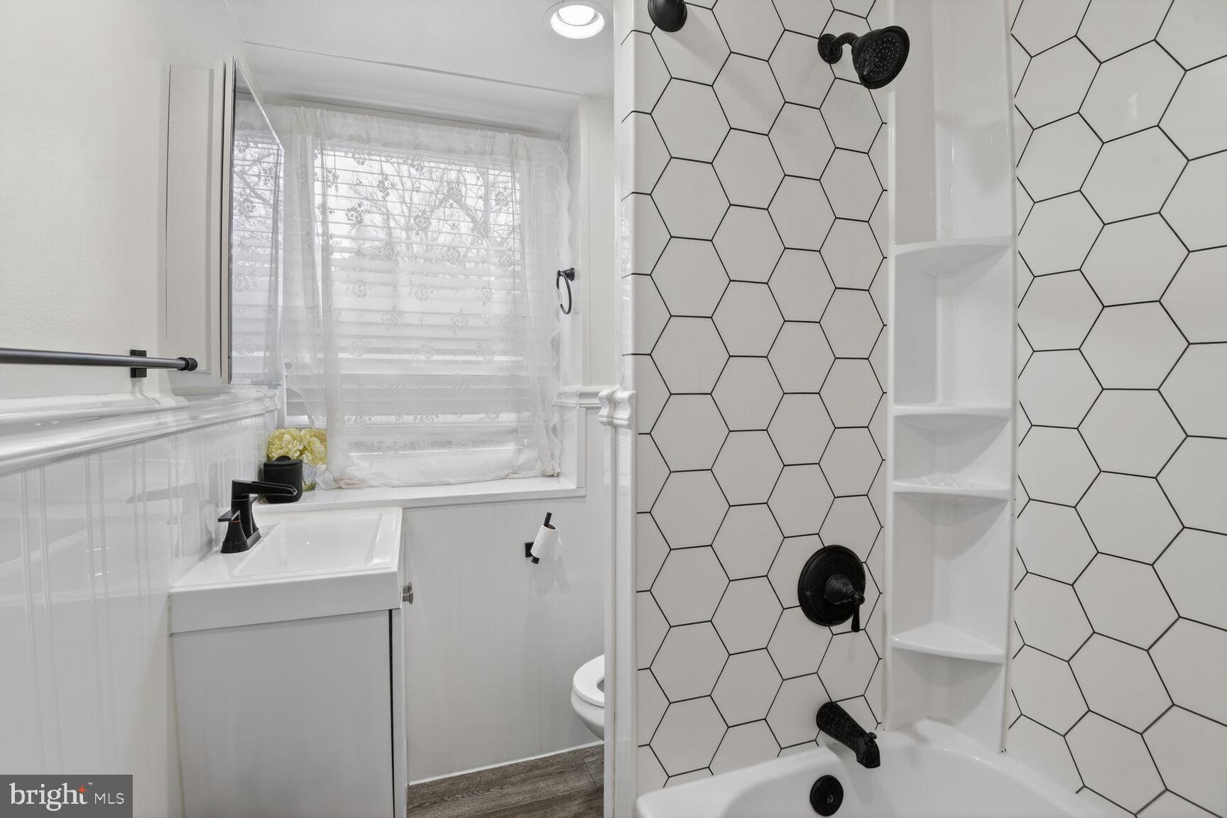 8110 Sheriff Road Landover, MD 20785 - Photo 13 of 15 a bathroom with a sink and a shower curtain