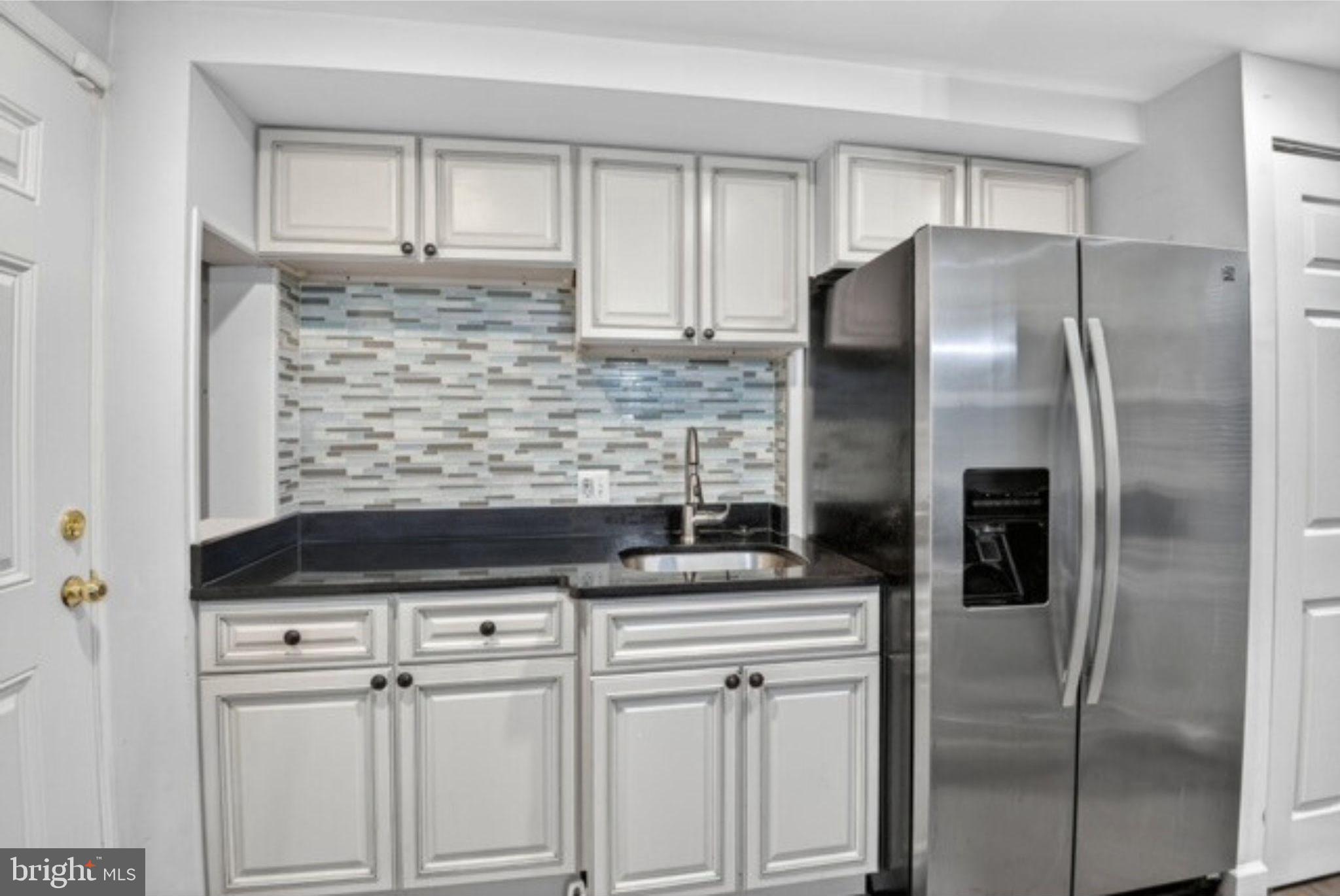 8110 Sheriff Road Landover, MD 20785 - Photo 6 of 15 a kitchen with stainless steel appliances kitchen island a refrigerator sink and cabinets