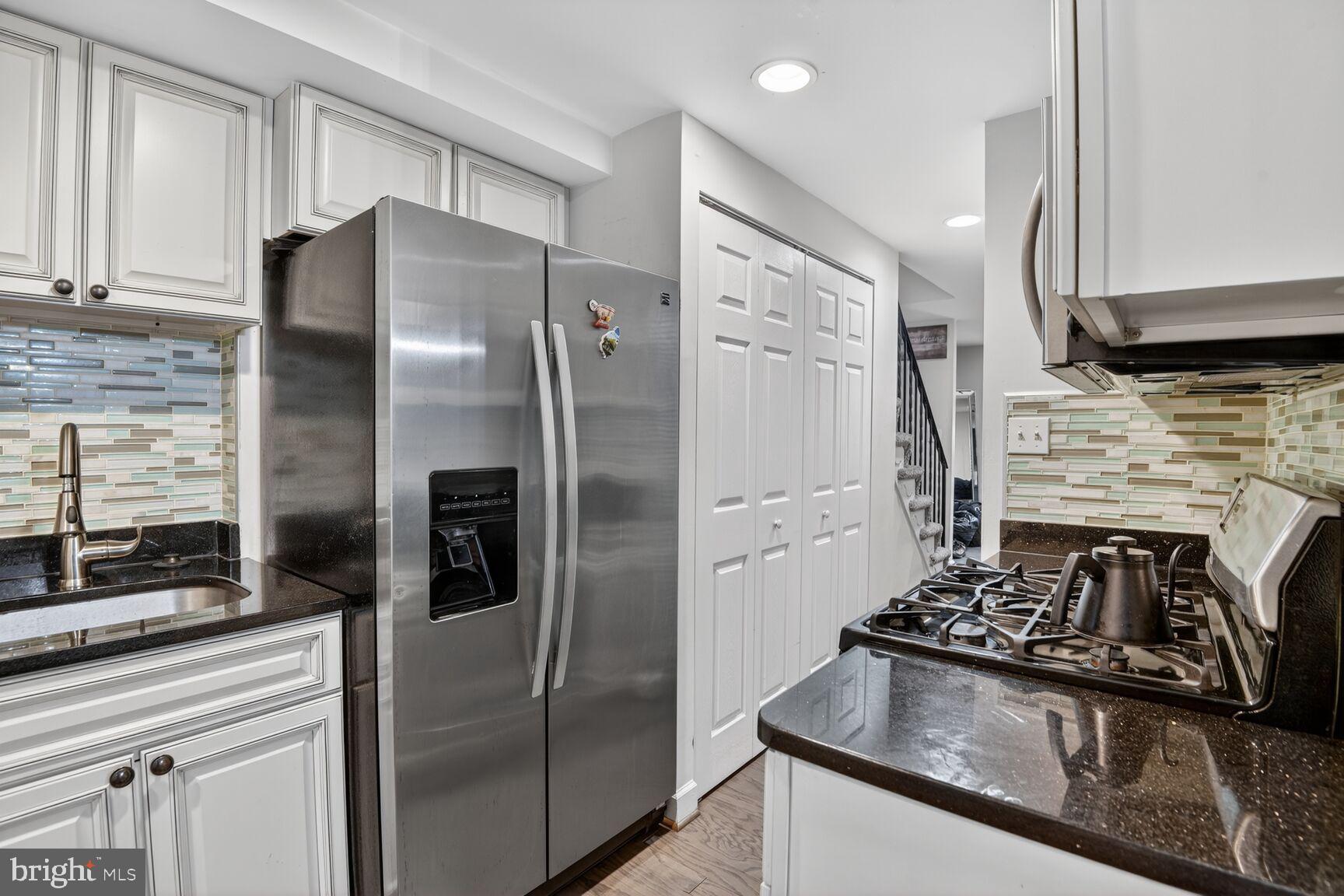8110 Sheriff Road Landover, MD 20785 - Photo 8 of 15 a kitchen with stainless steel appliances granite countertop a refrigerator and a stove
