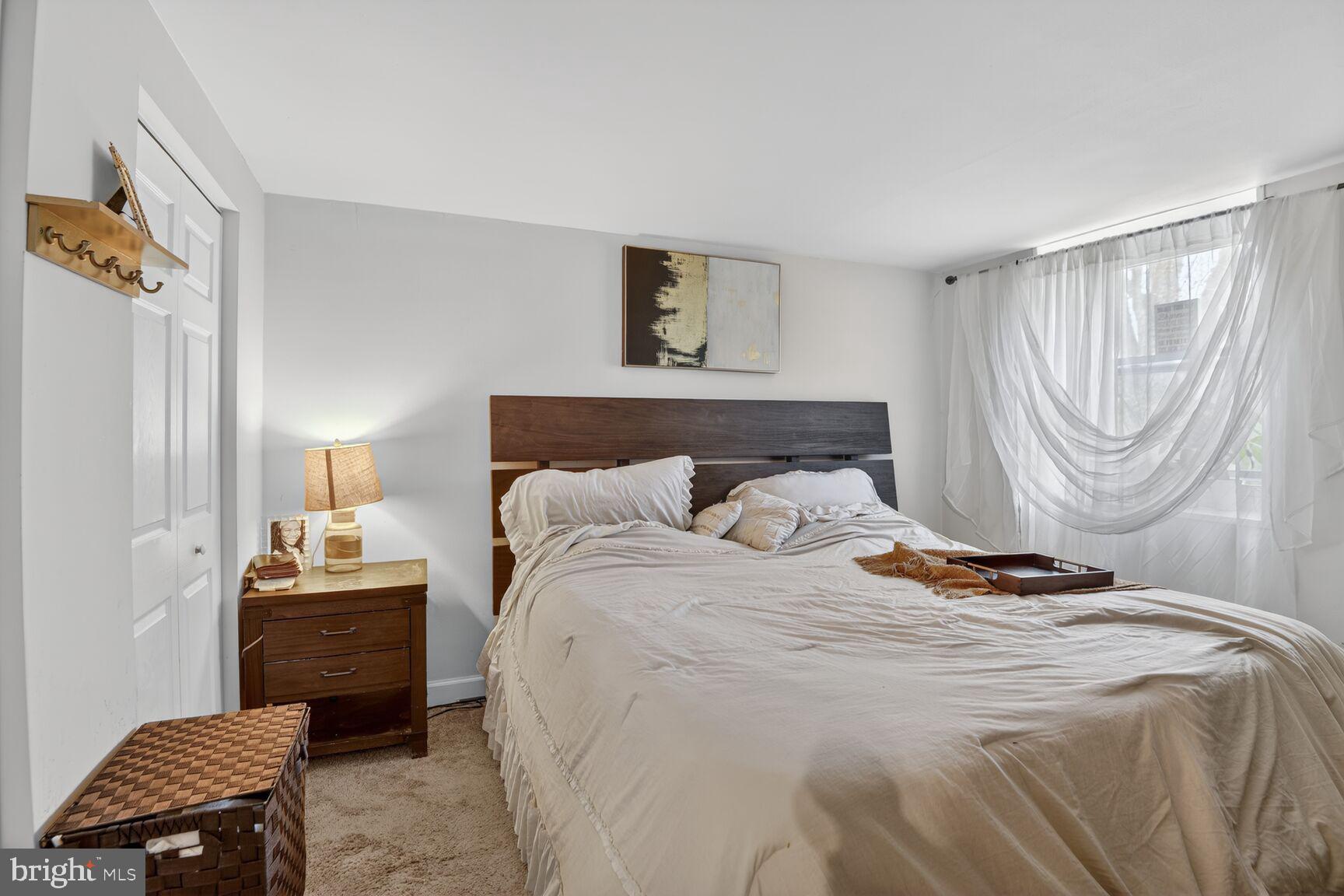 8110 Sheriff Road Landover, MD 20785 - Photo 10 of 15 a bedroom with a bed and a lamp on the dresser