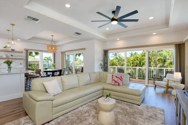 a living room with furniture and a large window with garden view