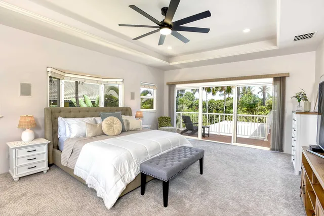 a bedroom with a bed and a large window with the outer view