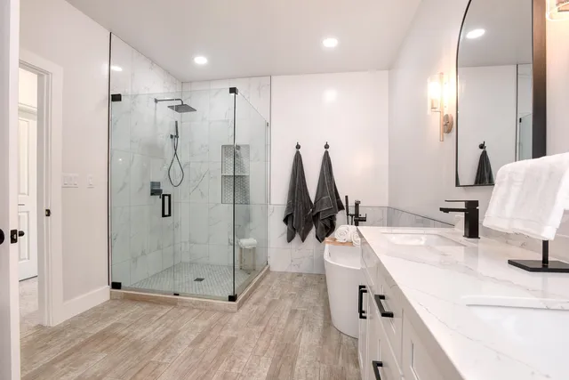 a bathroom with a tub sink and mirror