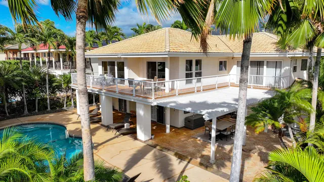 a view of house with swimming pool and glass windows