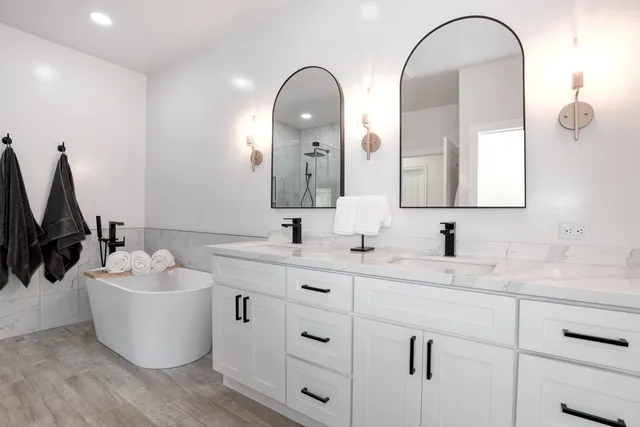 a bathroom with a double vanity sink and mirror