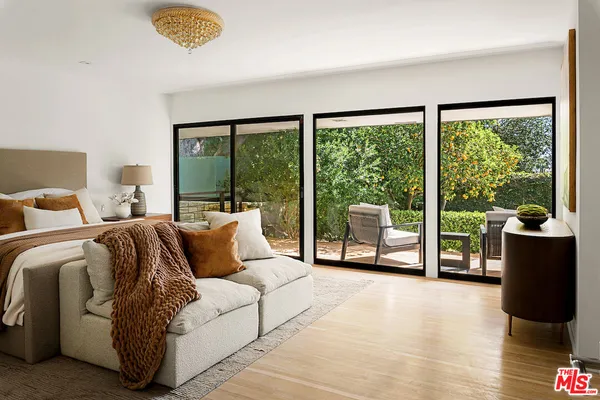 a spacious bedroom with a bed and a large window