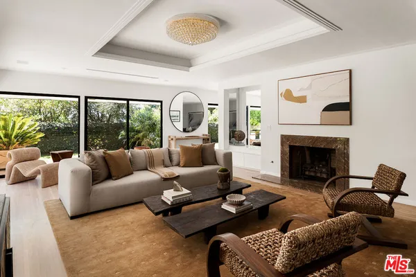 a living room with couch and a floor to ceiling window