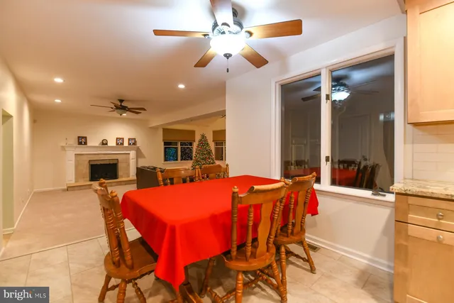 a view of a dining room with furniture and a fireplace