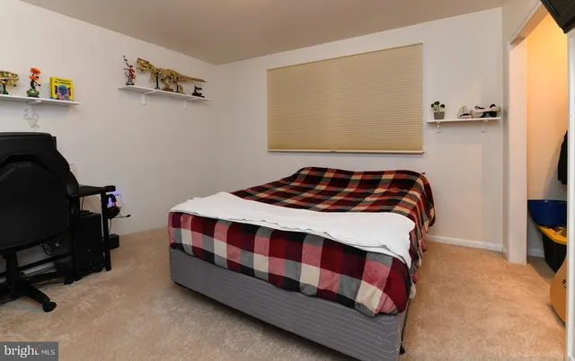 a bedroom with a bed and a chair in it