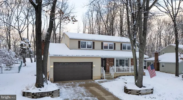 a front view of a house with a yard and fountain