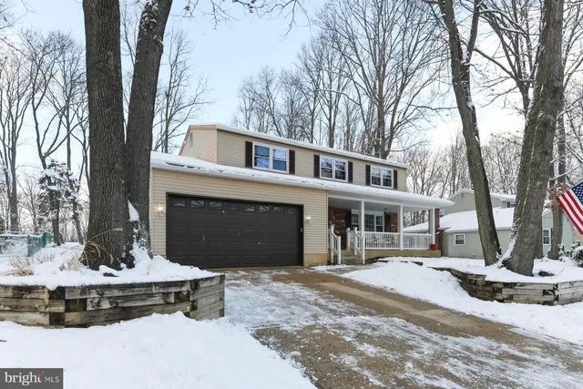 a front view of a house with a yard and fountain