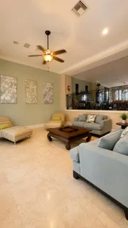 a living room with furniture and a ceiling fan