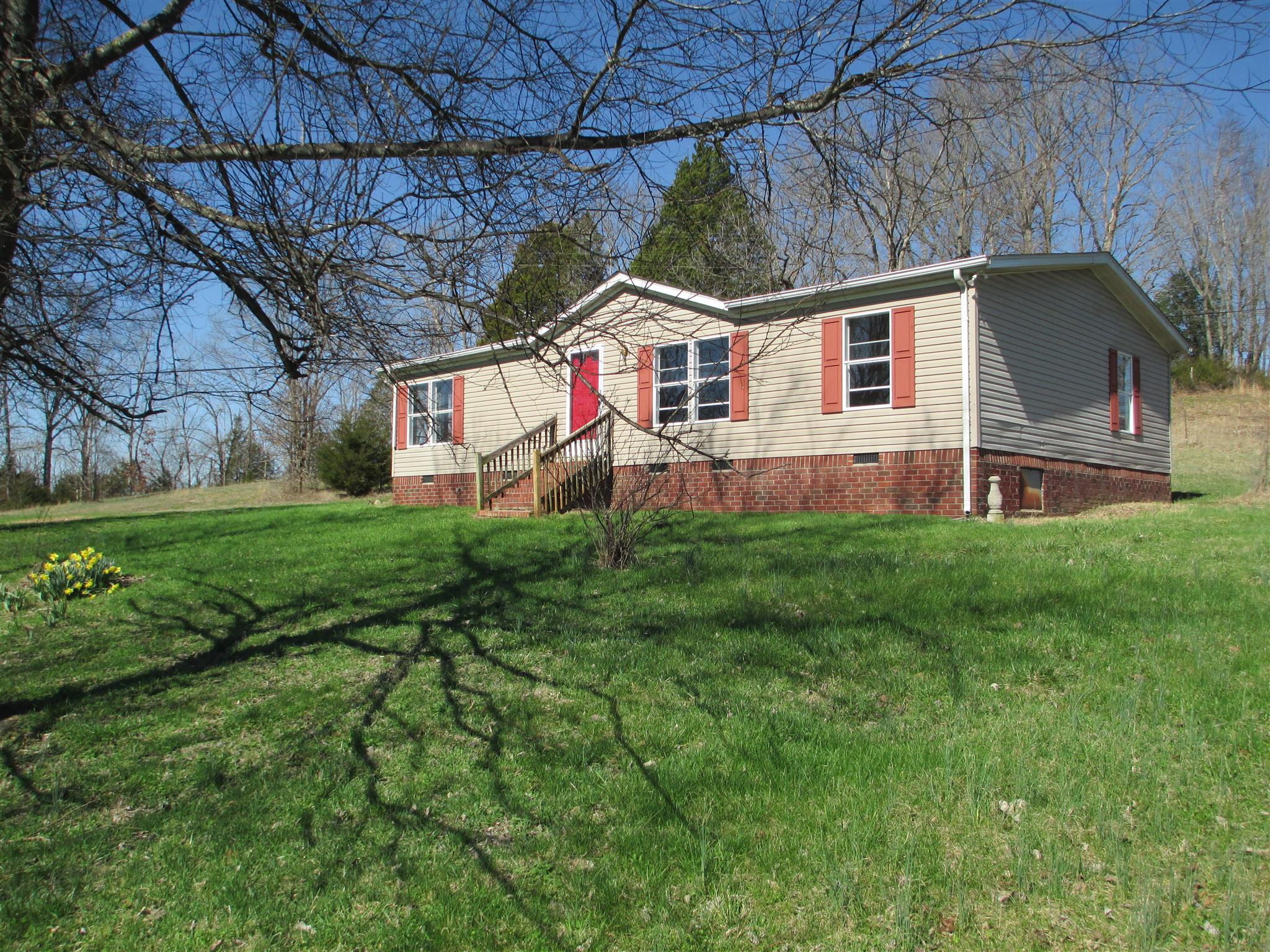 a front view of house with yard and green space
