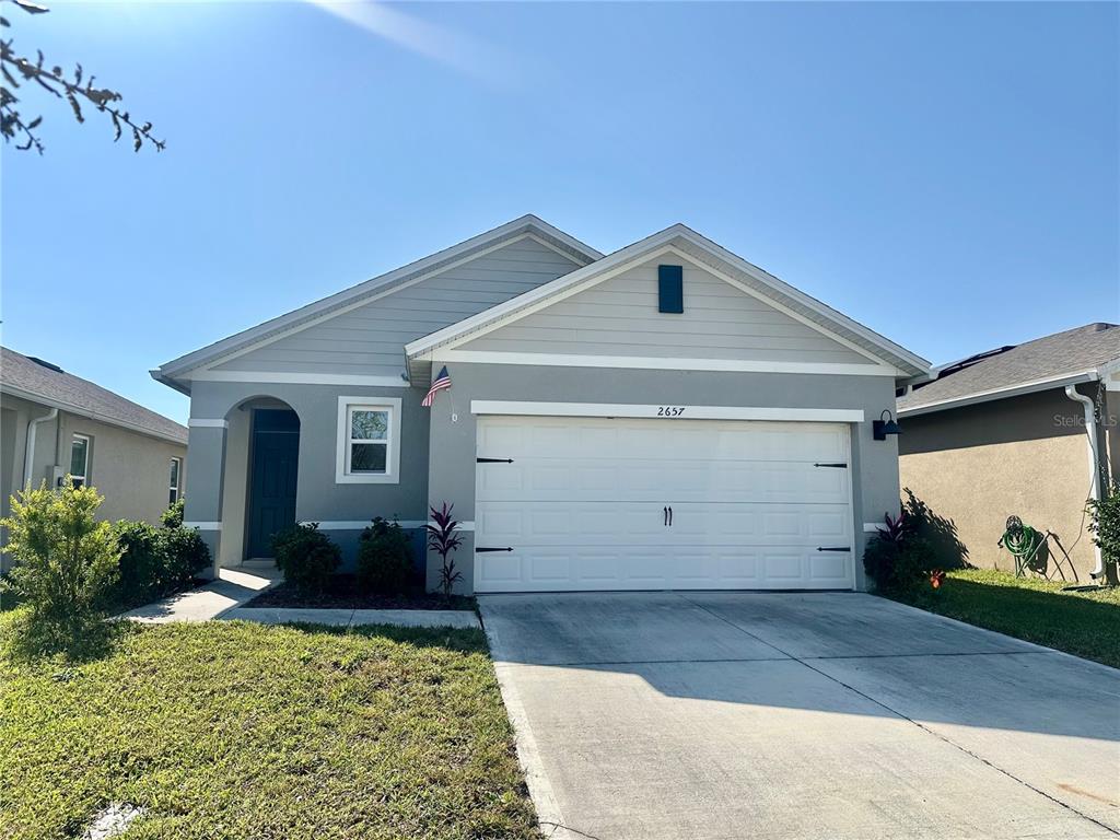2657 Harmonia Hammock Road Harmony, FL 34773 - Photo 1 of 5 a front view of a house with garden