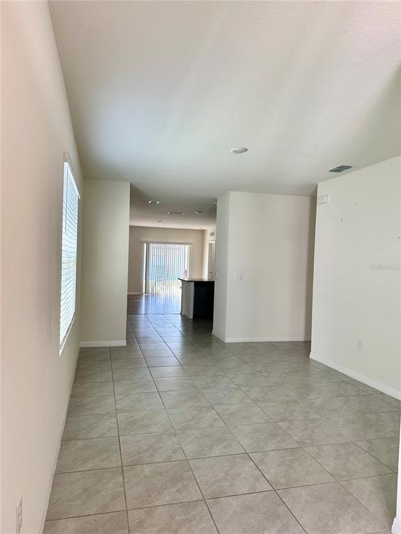 2657 Harmonia Hammock Road Harmony, FL 34773 - Photo 2 of 5 wooden floor in an empty room and a window