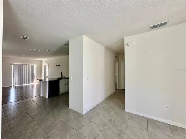 a view of a kitchen with a sink and refrigerator