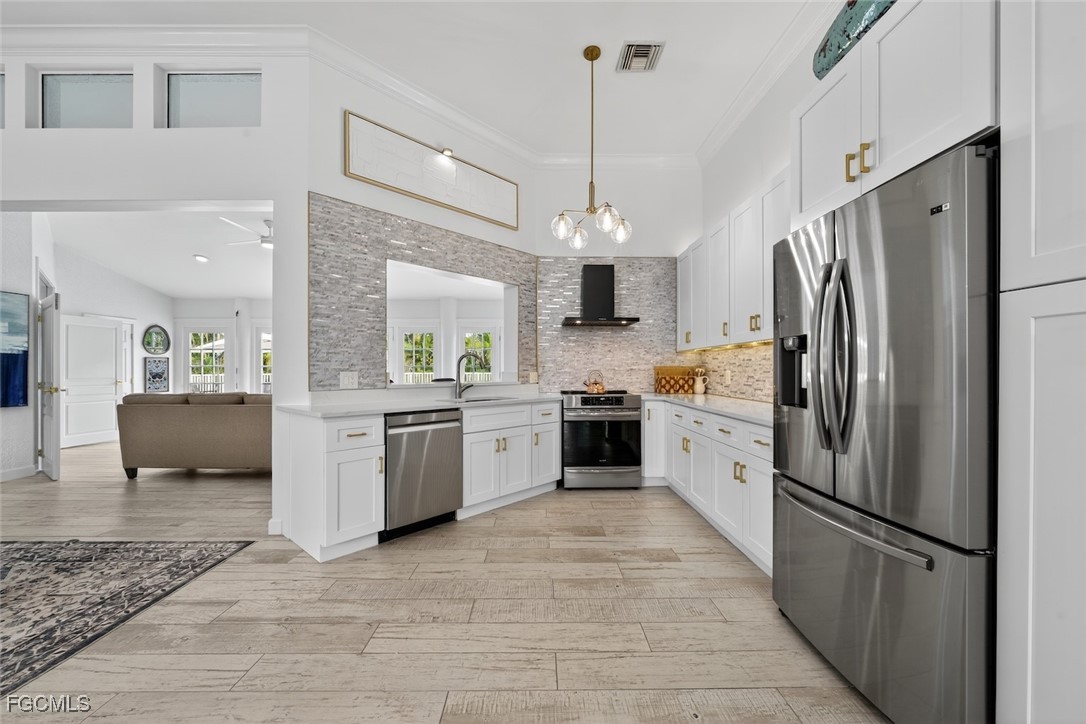 13570 Harbour Ridge Drive Fort Myers, FL 33908 - Photo 18 of 50 a kitchen with a refrigerator a sink and a stove