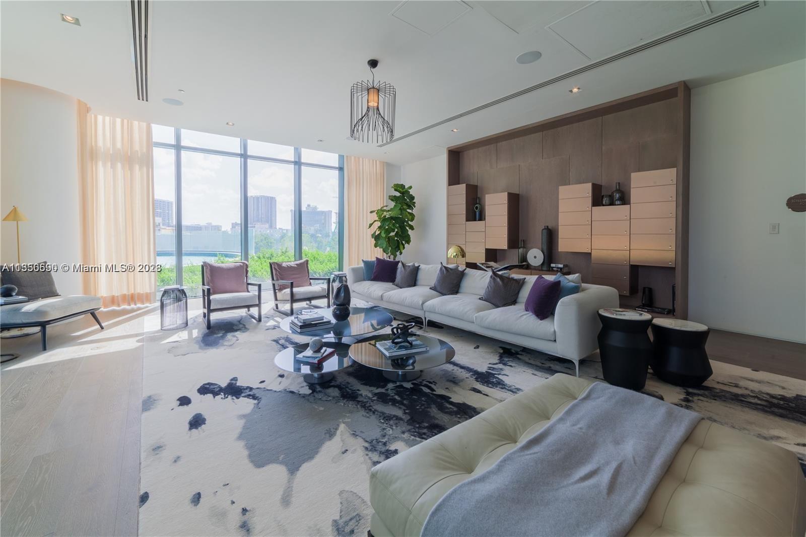 650 Northeast 32nd Street, Unit 4208 Miami, FL 33137 - Photo 14 of 18 a living room with furniture large windows and wooden floor