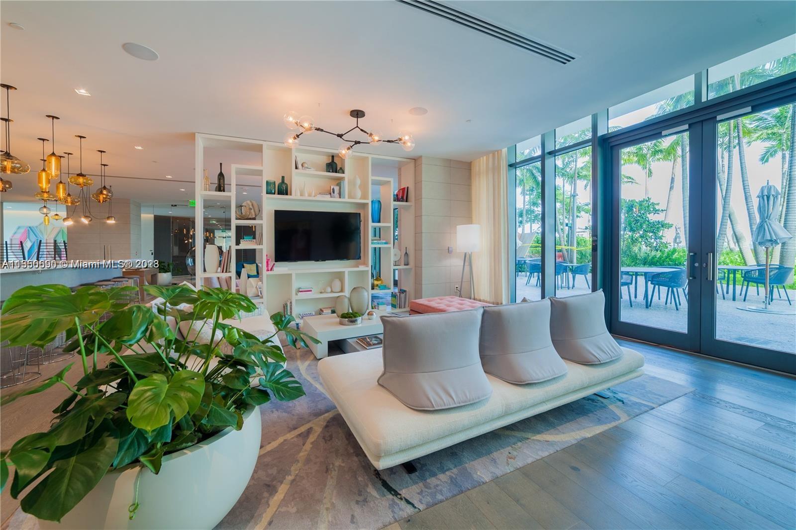 650 Northeast 32nd Street, Unit 4208 Miami, FL 33137 - Photo 15 of 18 a living room with patio furniture and a flat screen tv