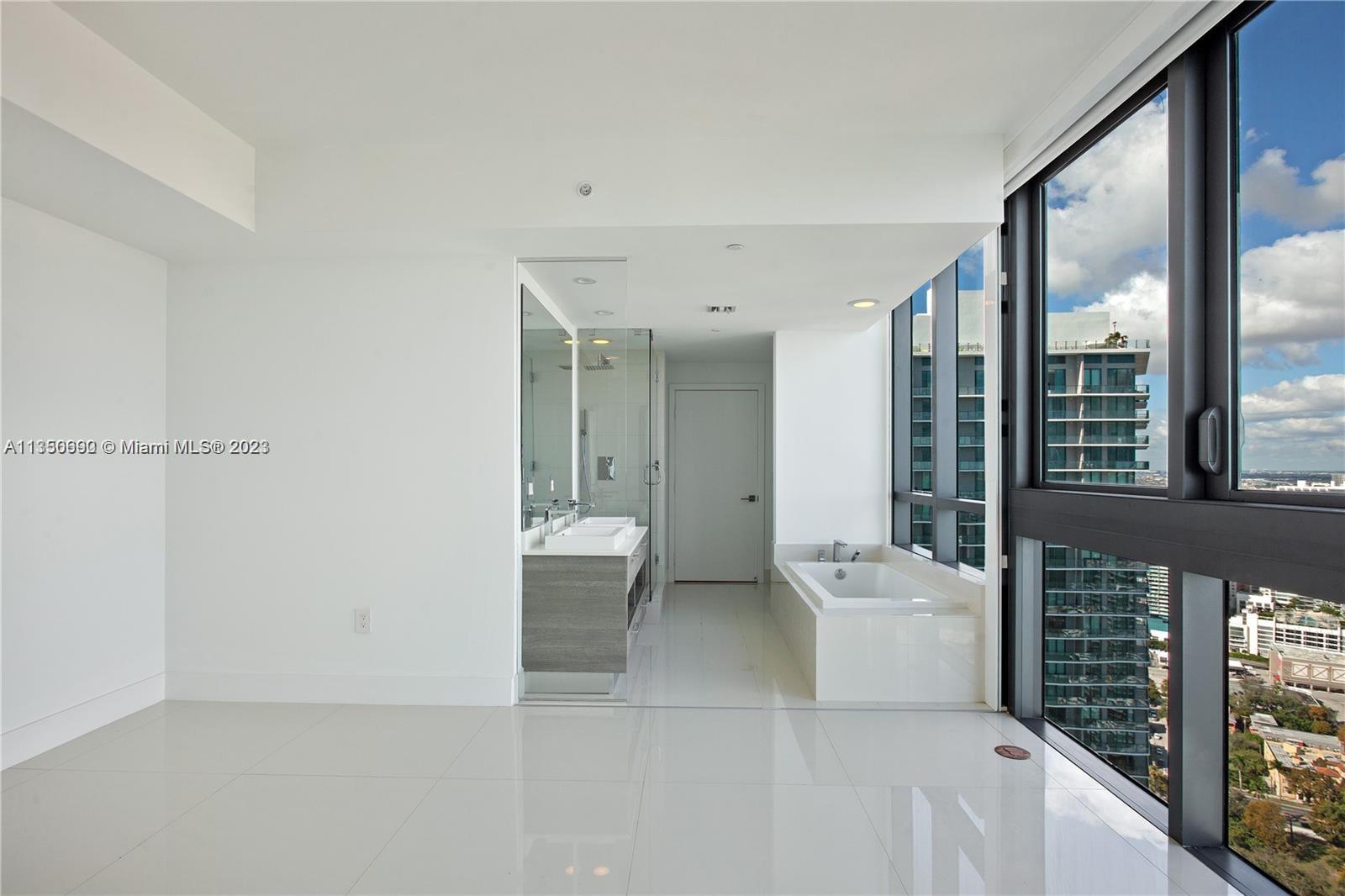 650 Northeast 32nd Street, Unit 4208 Miami, FL 33137 - Photo 2 of 18 a bathroom with a sink a toilet and shower
